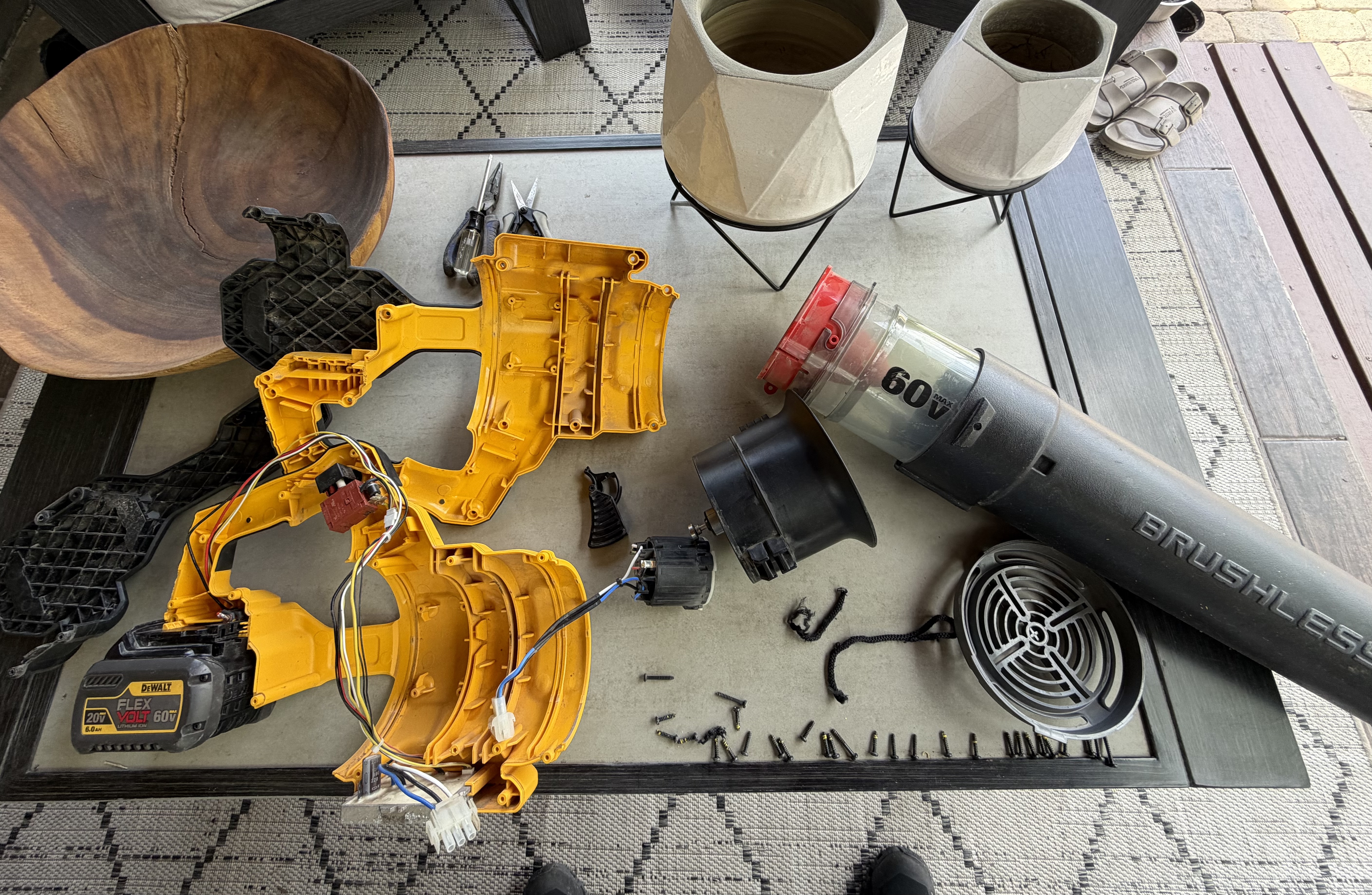 The aftermath — DeWalt 60V disassembled on the patio table